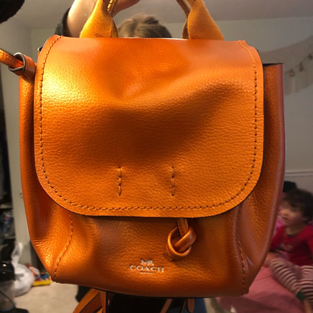 Coach Brand mini backpack a metallic orange color